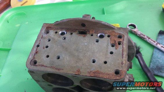 carburetor base with bolt holes and rust