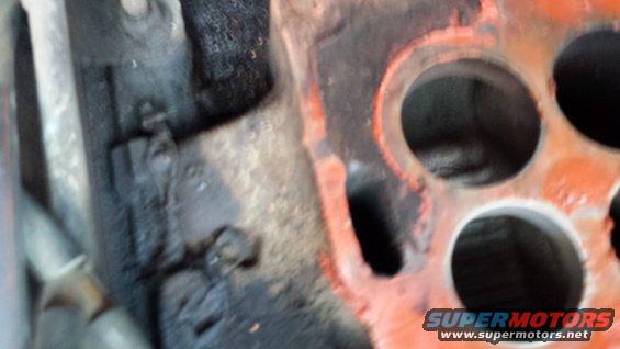 Close-up of engine part with orange and black coloration