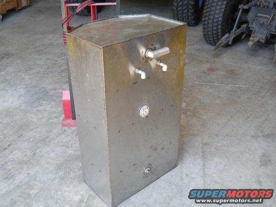 Rectangular metal fuel tank with two spouts and a circular gauge on the front