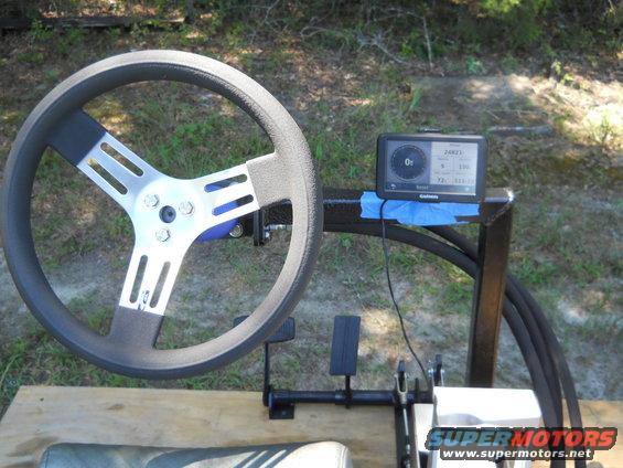 Aftermarket steering wheel with a Garmin GPS unit mounted nearby