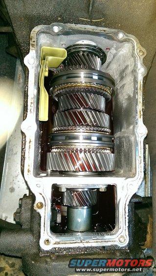 Close-up of internal transmission gears with red fluid