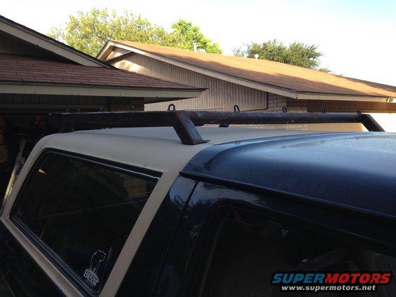 1993 Ford Bronco roof rack, tan and dark blue, side view, with a 'Bear' sticker on the rear window