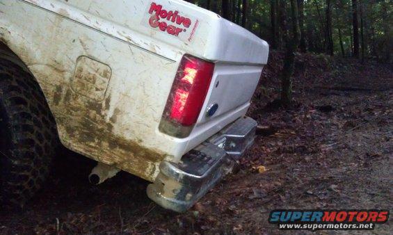 White Ford Bronco rear, covered in mud, with a chrome bumper and a red taillight