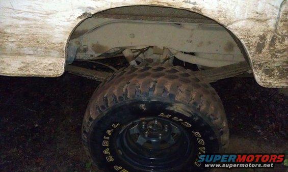 Rear wheel well and tire with 'Mud Rover' text