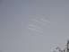 1995 Mercury Grand Marquis - Contrails streak across the sky, suggesting aircraft activity.