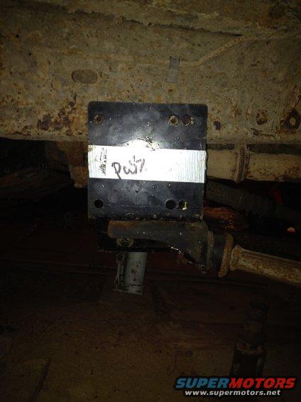 Underbody part with handwritten label 'Pw7' on white tape