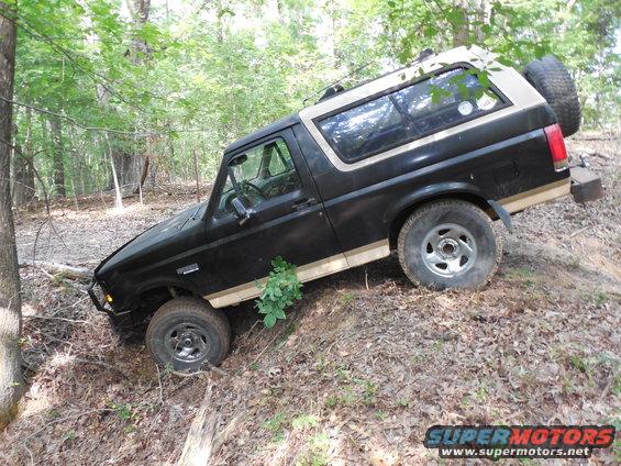 newstuck2.jpg I was just screwing around in 2WD and ran down into this ditch and got hung on this log.  After locking the hubs & working the wheels, I blew a hub lock.  Eventually, I winched out forward, drove around and came out a different trail.