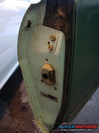 1969 Ford Torino door latch mechanism with visible VIN plate