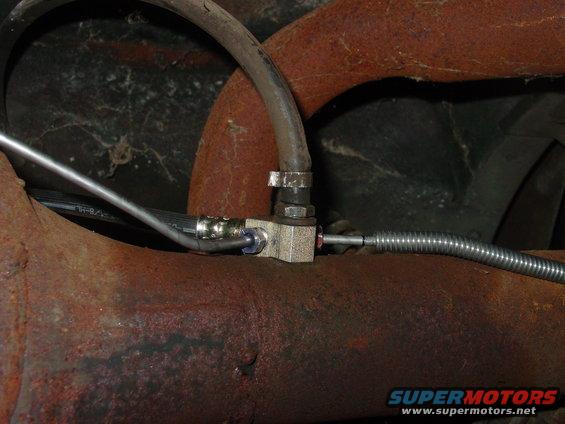 Brake line junction block connected to rusty pipes and hoses