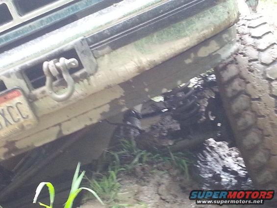 1996 Ford Bronco front bumper and tire stuck in mud