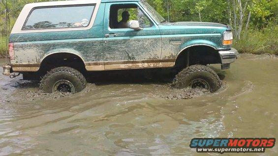 1996 Ford Bronco driving through mud