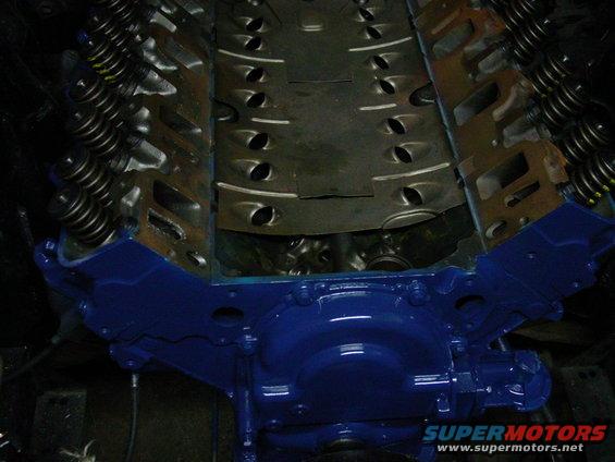 Blue painted engine block with exposed valve springs and intake manifold
