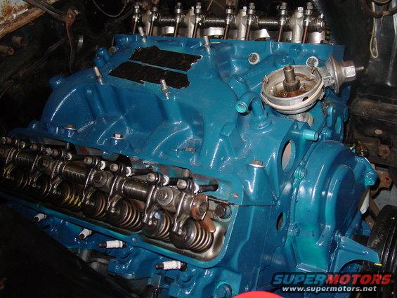 Blue painted engine block showing valve train components and spark plugs