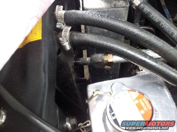 Engine bay hoses and radiator cap with 'Danger Warning' text