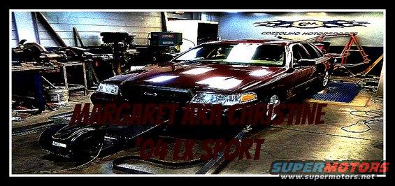 2004 Ford Crown Victoria on a dynamometer in a garage with "MARGARET AND CHRISTINE 2004 LX SPORT" text overlay