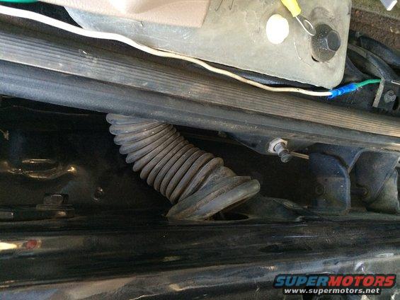 Corrugated wire loom and wiring under a vehicle's interior trim panel
