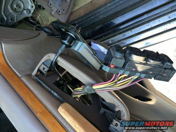Interior door panel removed, exposing wiring harness and control module