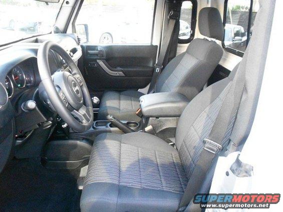 Jeep interior showing front seats, dashboard, and steering wheel
