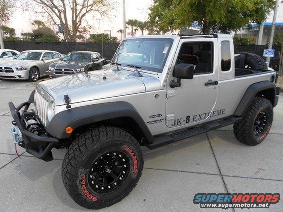 Silver Jeep JK-8 Extreme pickup conversion with off-road tires and winch