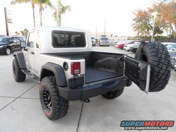 Jeep Wrangler with a truck bed conversion, spare tire mounted on the tailgate