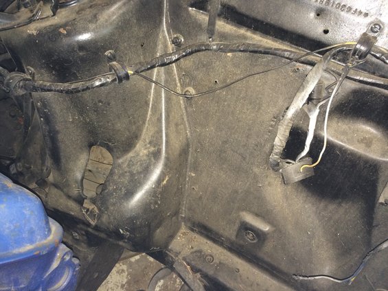 1964 Ford Fairlane engine bay, black metal, wiring harness, blue fluid reservoir