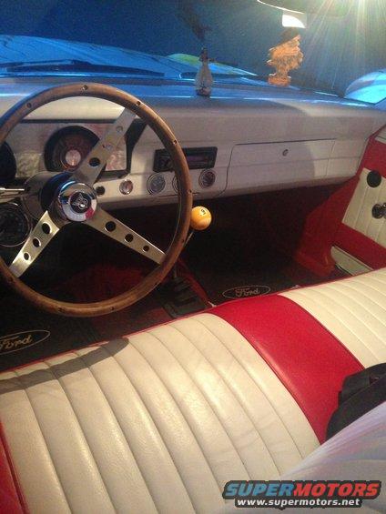 1966 Ford Ranchero interior with red and white seats, wood steering wheel, and floor mats