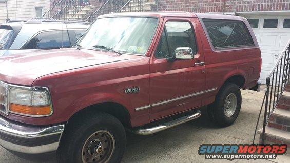 Red 1996 Ford Bronco parked in driveway, 3q-front view