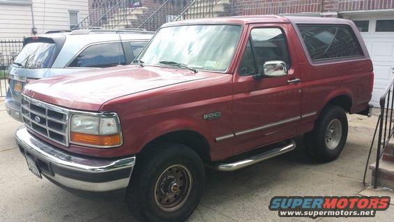 Red 1996 Ford Bronco parked next to a silver SUV