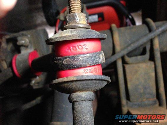 Red suspension bushing with stamped numbers 4802 and 2011