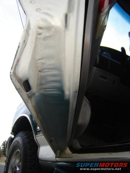 White and green door jamb of a 1996 Ford Bronco