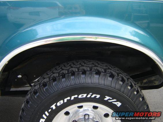 Teal 1996 Ford Bronco wheel well with chrome trim and All-Terrain T/A tire