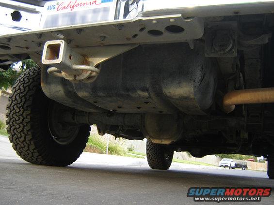 Undercarriage view of vehicle with trailer hitch and spare tire