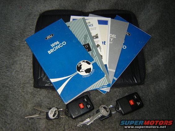 1996 Bronco owner's manual, other Ford documents, and two sets of keys on carpet