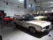 1971 Ford Ranchero - A 1971 Oldsmobile Cutlass Supreme convertible, marked as an official pace car, is displayed indoors among other vehicles.