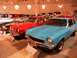 1971 Ford Ranchero - Several vintage cars are on display in a museum setting, including a blue Chevrolet Vega.