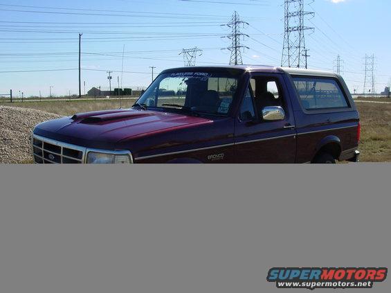 Maroon 1996 Ford Bronco with a white roof, seen from the front-right