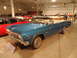 1971 Ford Ranchero - A blue convertible is displayed in a museum alongside other classic vehicles.
