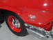 1971 Ford Ranchero - Close-up of a red car's fender, a "409" badge with a checkered flag emblem.
