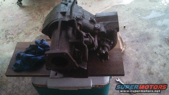 Heavy cast iron transmission part on wooden board with blue rags