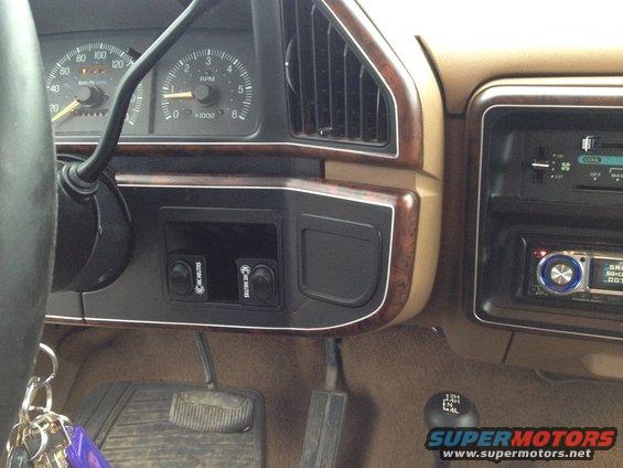 1989 Ford Bronco interior dashboard with wood trim, gauges, and aftermarket radio