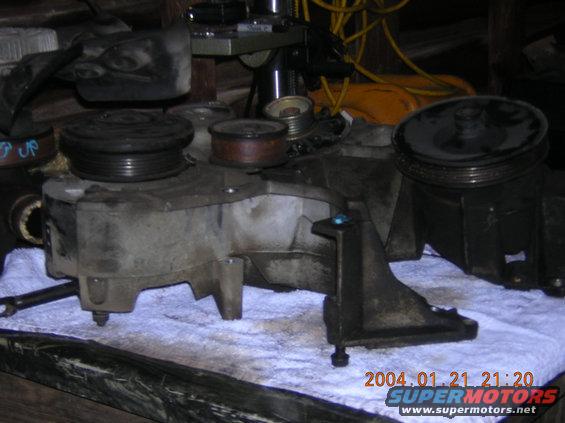 Alternator and power steering pump assembly on a white cloth
