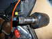 1993 Mazda MX-3 - Close-up of a CV axle joint and an oil cooler, likely automotive parts.