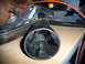 1993 Mazda MX-3 - A greasy automotive part is shown in close-up, with other engine components and a red can visible in the background.