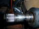 1993 Mazda MX-3 - Close-up of a worn driveshaft component, showing splines and machined grooves.