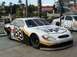 1979 Ford Bronco II - A white and black UPS race car with the number 88 is parked next to another race car.