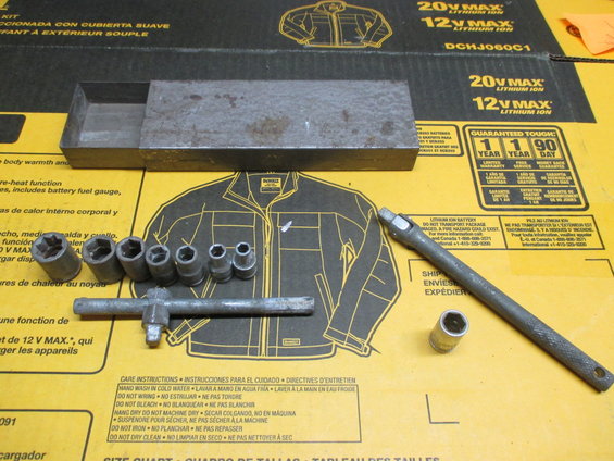 Socket wrench set with a metal box and extension bar on a yellow background with diagrams