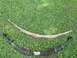 1979 Ford Bronco - A pair of leaf springs, one showing significant rust and the other painted black, are displayed on a grassy surface.