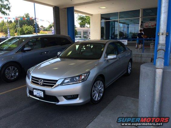 Silver sedan parked at a dealership, front 3/4 view. License plate frame reads 'Honda'