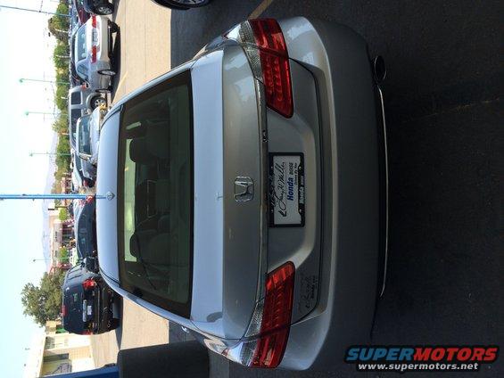 Rear view of a silver Honda Accord sedan parked in a lot with other cars. License plate frame says 'Honda Boise'