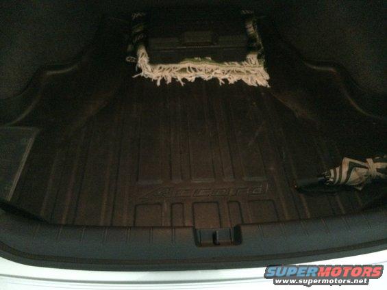 Trunk of a 2014 Honda Accord with a rubber mat and a folded umbrella